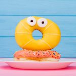 Plate,With,Surprised,Yellow,Donut,On,Blue,Background.,Funny,Donut