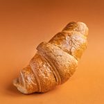 croissant on colored background fresh bakery sweet dessert bun snack healthy meal top view copy space for text food background rustic image