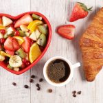 fruit salad, coffee cup and croissant