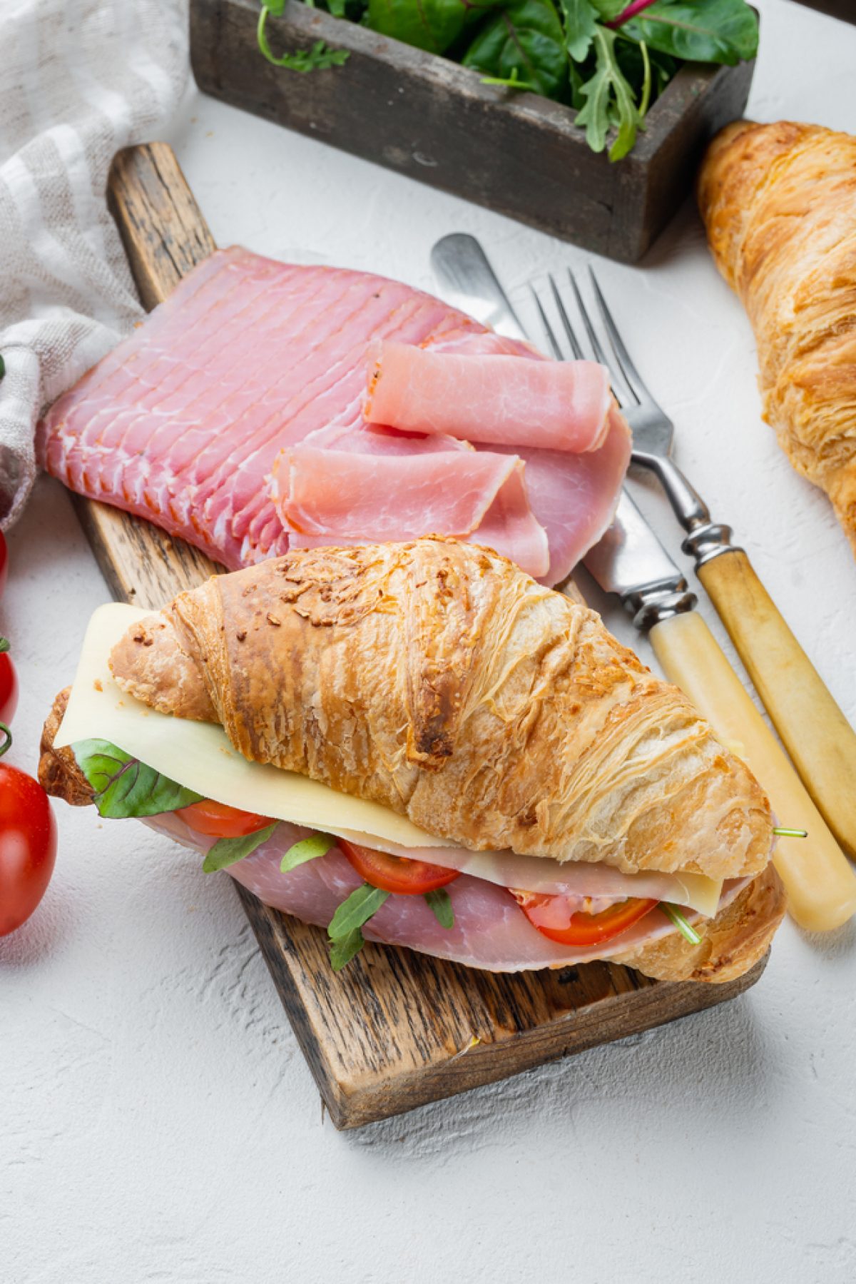 Classic BLT croissant sandwiches set, with herbs and ingredients, on white stone background