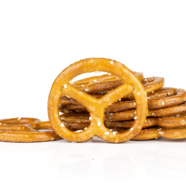 Lot of whole mini salted pretzels heap isolated on white background