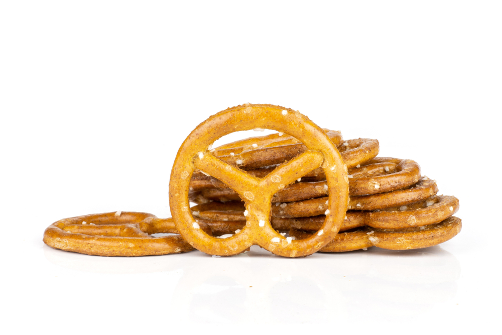 Lot of whole mini salted pretzels heap isolated on white background