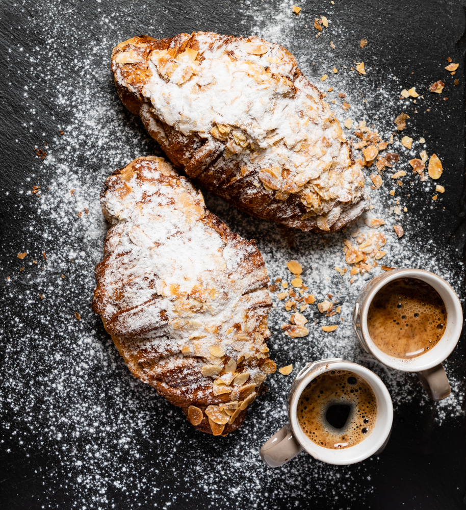 Croissants with almonds on the black background